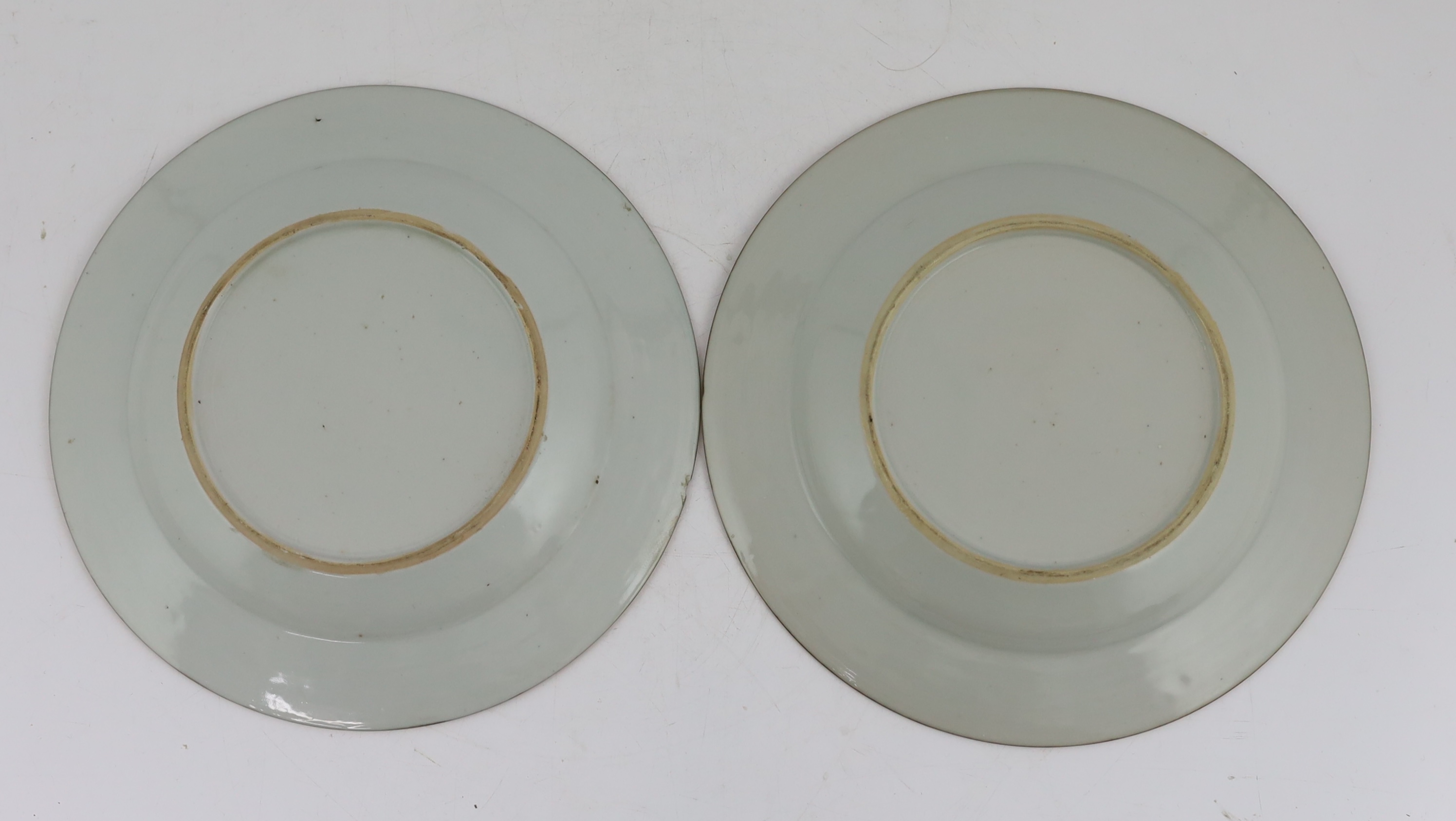 A pair of Chinese famille rose ‘landscape’ plates, Yongzheng-Qianlong period, small edge chip
